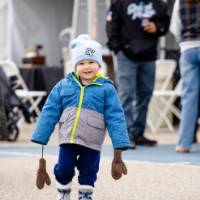 Little Laker smiles wearing GV hat